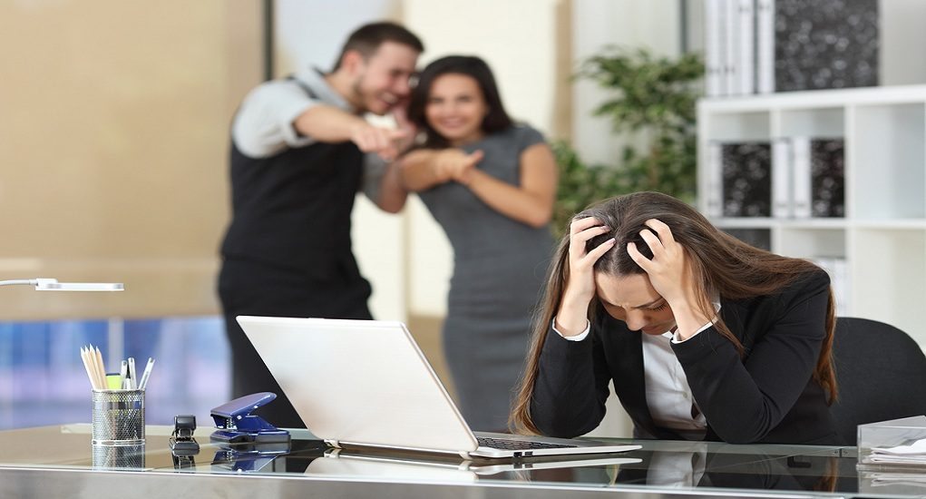 Two,Businesspeople,Bullying,A,Sad,Colleague,That,Is,Sitting,In